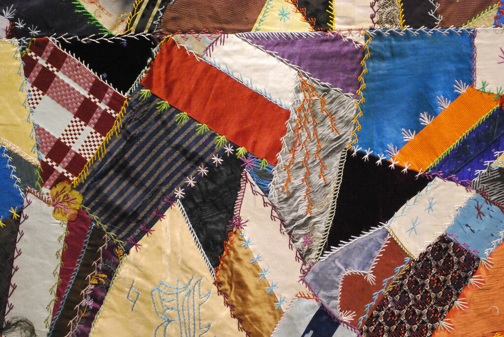 Crazy quilt with intricate stitching.