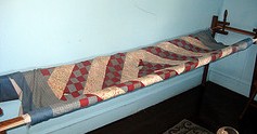 Amish quilt on quilt frame